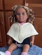 Doll wearing poncho
